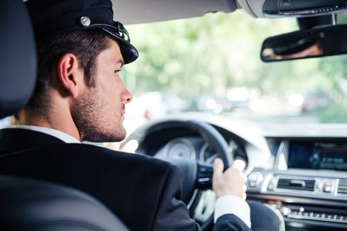 Portrait of a handsome male chauffeur riding car-1